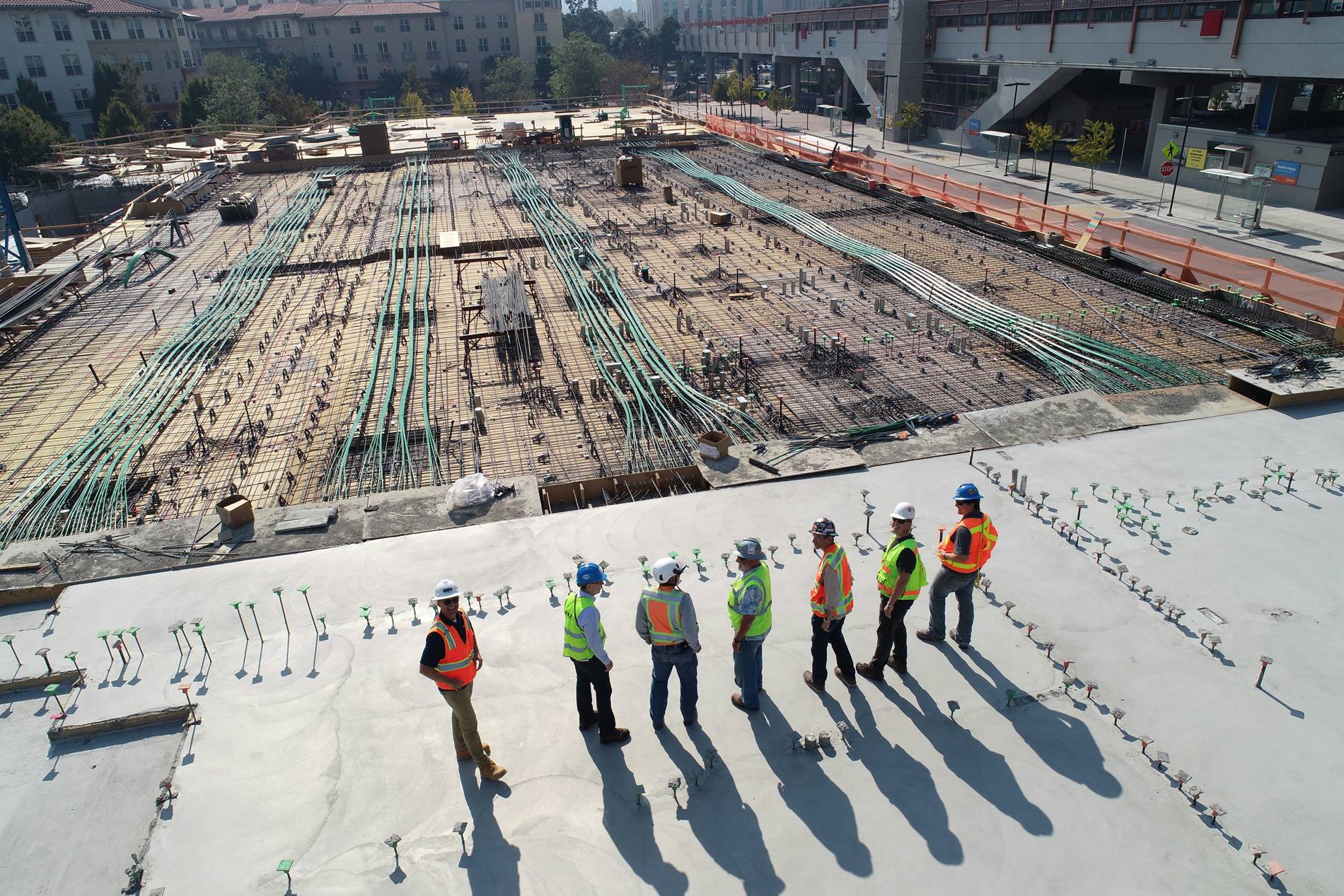 people standing around hospital construction site