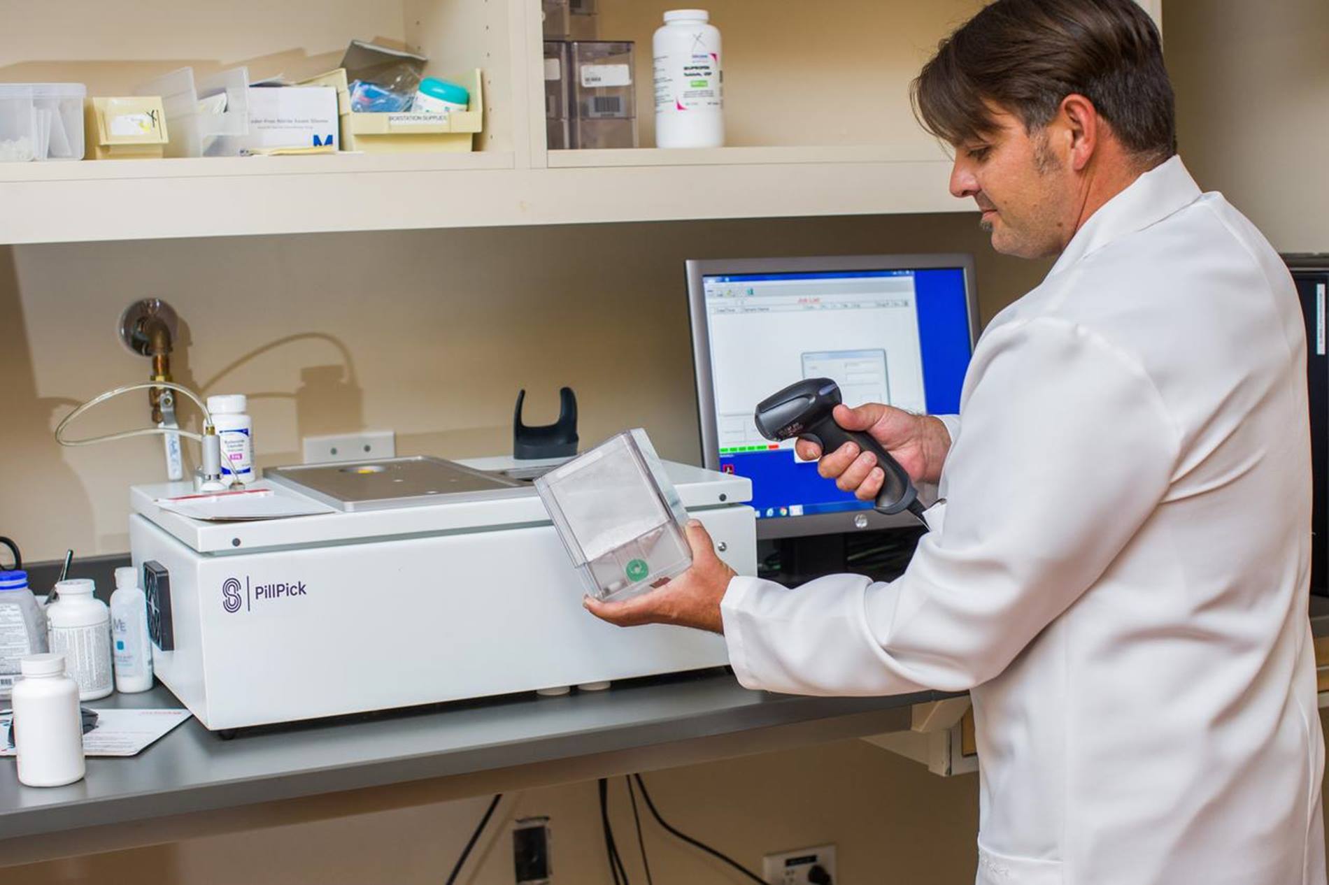 pharmacist scanning medication container