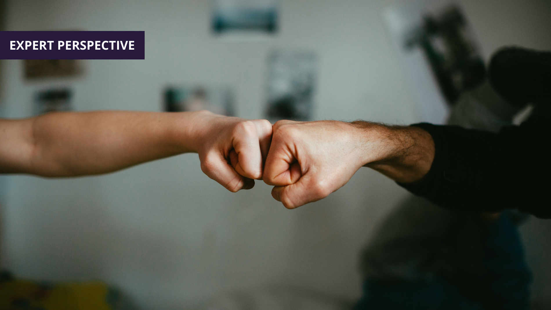 two people fist bumping