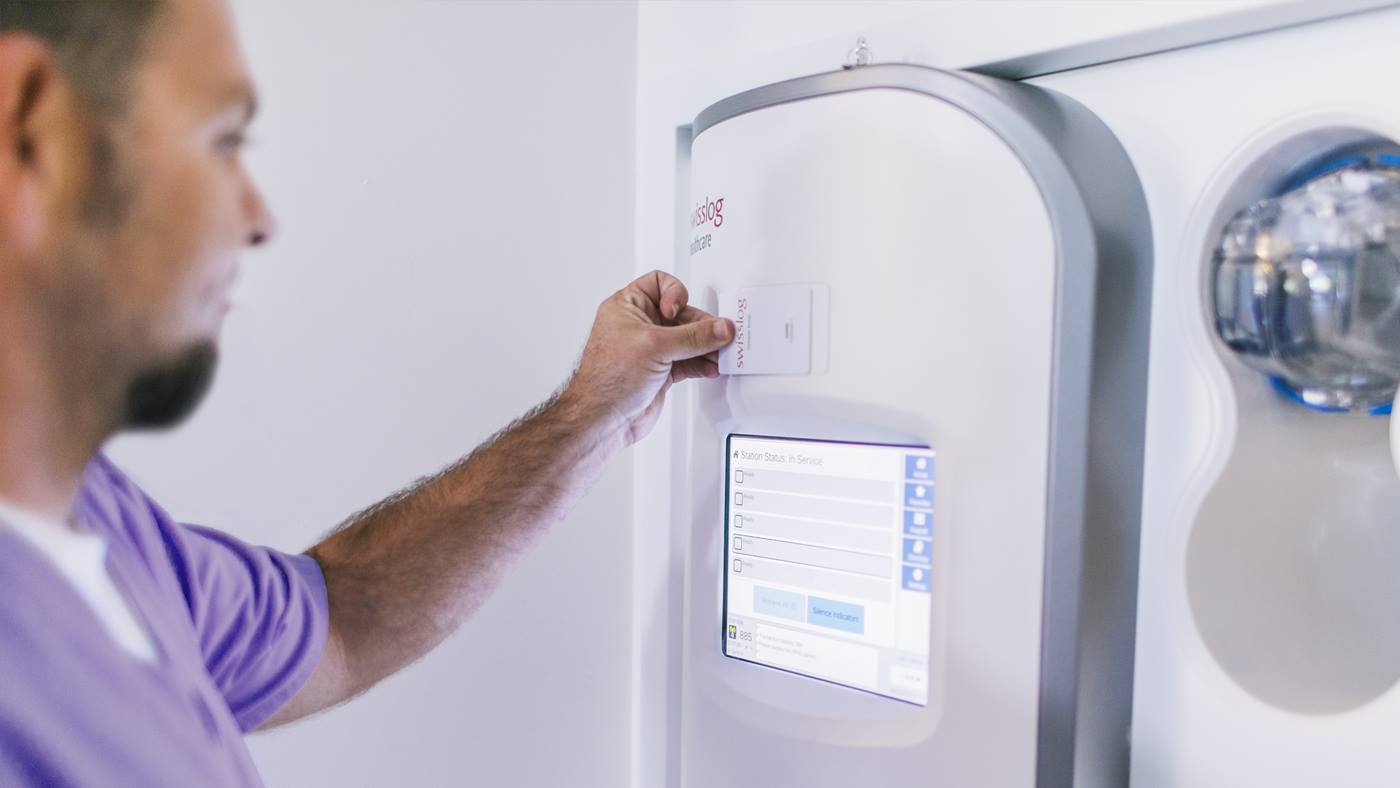 A technician operates a hospital pneumatic tube system station that has been modernized for peak system performance operation.