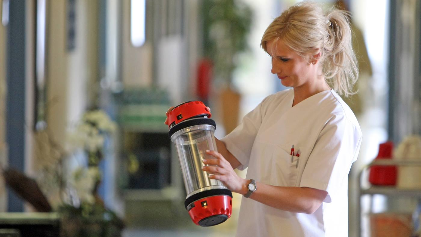 TranspoNet Pneumatic Tube System carrier being prepared for use by a technician