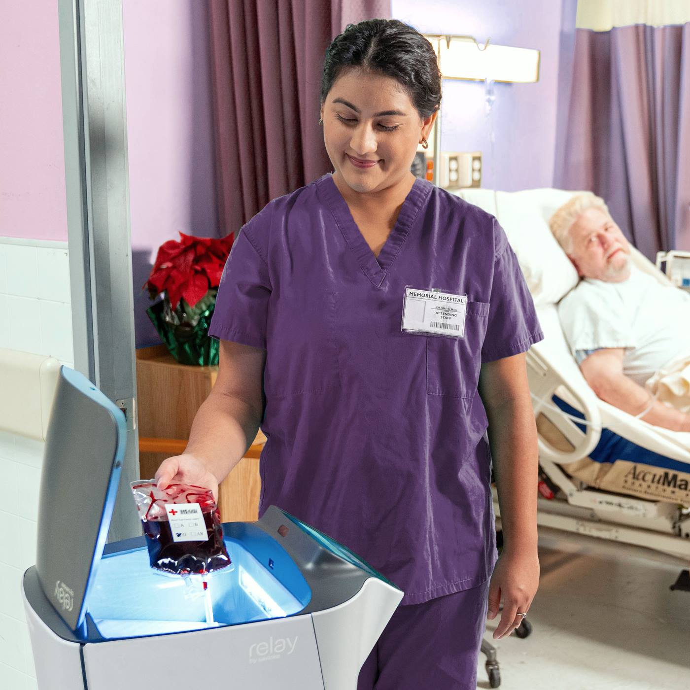 Nurse puts blood sample into Relay