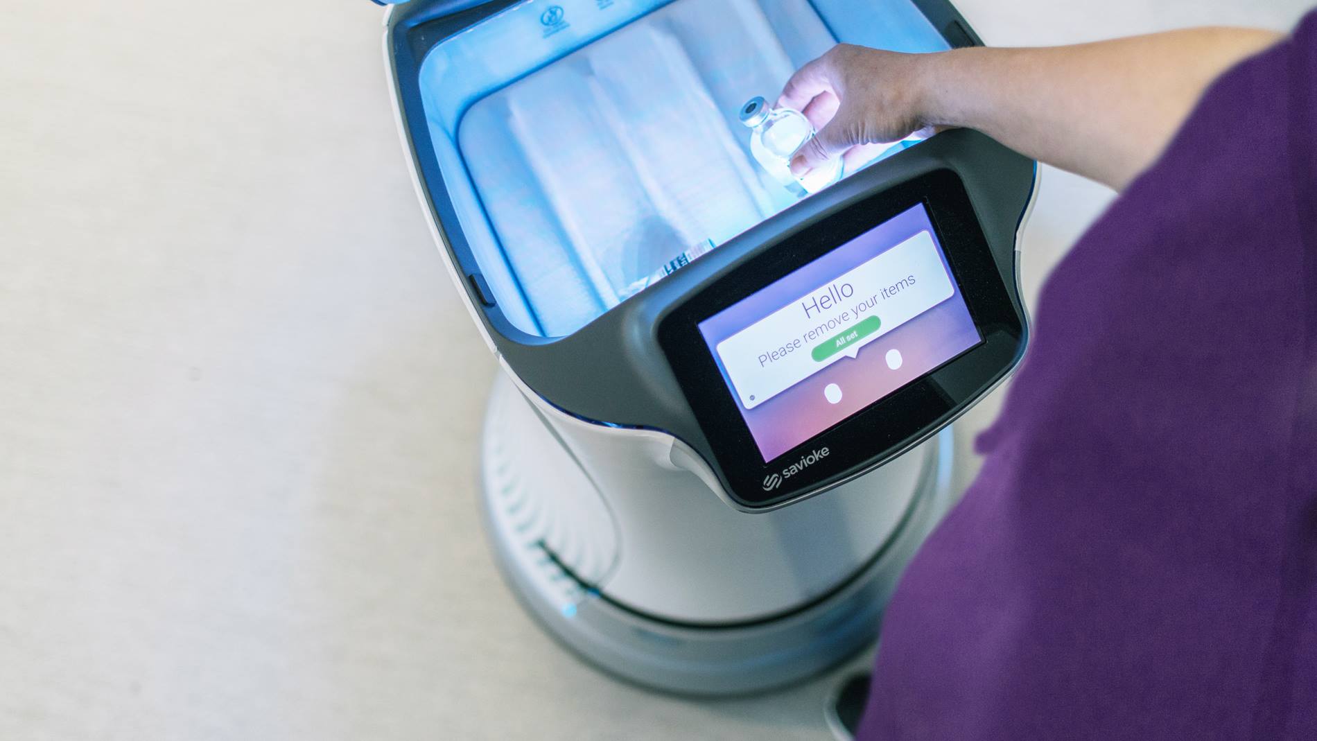 Nurse loads medication into the Relay® autonomous service robot for hospitals.