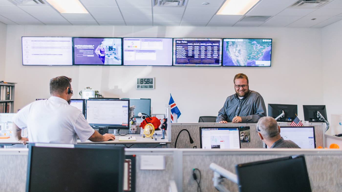Swisslog Healthcare remote system monitoring team working together to provide around-the-clock technical support for pneumatic tube system customers. 