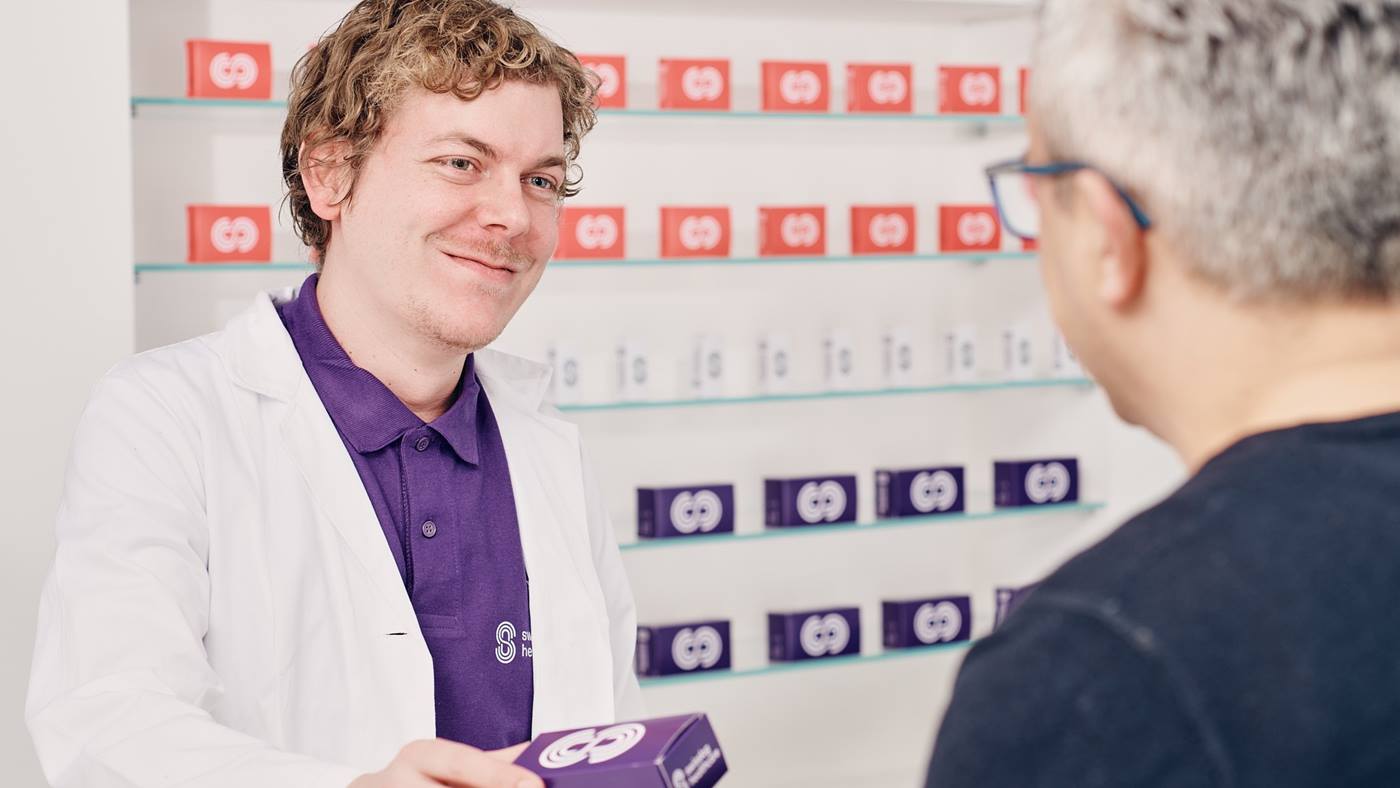 Pharmacist serving a customer in the Open Pharmacy 